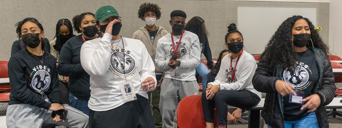 group of students wearing branded shirts and nametags during the vibes conference